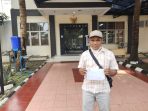 Oom Abdul Rahman di depan kantor Kompolnas memegang tanda terima pengaduan